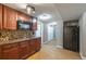 Basement kitchenette boasts dark wood cabinets, granite countertops, and modern appliances for added convenience at 2025 Fairway Crossing Dr, Woodstock, GA 30188