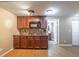 Basement kitchenette featuring wooden cabinets, mosaic backsplash, and a sink, offering practical amenities at 2025 Fairway Crossing Dr, Woodstock, GA 30188