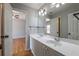 Bathroom with double vanity sink, framed mirror and modern light fixtures at 2025 Fairway Crossing Dr, Woodstock, GA 30188