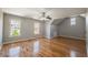 Bedroom with natural light, neutral paint, ceiling fan, and gleaming hardwood floors at 2025 Fairway Crossing Dr, Woodstock, GA 30188