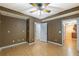 Bedroom featuring hardwood floors, neutral paint, and doorways to other rooms, and ceiling fan at 2025 Fairway Crossing Dr, Woodstock, GA 30188