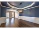 Elegant dining room with hardwood floors, navy blue walls, and modern light fixture at 2025 Fairway Crossing Dr, Woodstock, GA 30188