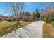 Long paved driveway leading to a beautiful brick home with well-manicured landscaping at 2025 Fairway Crossing Dr, Woodstock, GA 30188