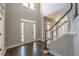 Bright foyer with hardwood floors, high ceilings, and an elegant staircase at 2025 Fairway Crossing Dr, Woodstock, GA 30188