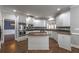 Bright kitchen with stainless steel appliances, granite counters, and white cabinetry with adjacent dining area at 2025 Fairway Crossing Dr, Woodstock, GA 30188