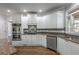 Well-equipped kitchen with granite counters, stainless appliances, and ample white cabinet storage at 2025 Fairway Crossing Dr, Woodstock, GA 30188