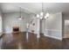 Spacious living room with hardwood floors, tall ceilings, brick fireplace, and natural light through windows at 2025 Fairway Crossing Dr, Woodstock, GA 30188