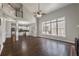 Open-concept living room featuring hardwood floors, high ceilings, and large windows with natural light at 2025 Fairway Crossing Dr, Woodstock, GA 30188