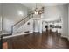Open-concept living room with hardwood floors and a staircase leading to the second floor at 2025 Fairway Crossing Dr, Woodstock, GA 30188