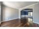Living room with hardwood floors showcasing open archway to the dining room, which has bold blue walls at 2025 Fairway Crossing Dr, Woodstock, GA 30188