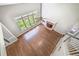 Spacious living room with hardwood floors, brick fireplace, and large windows offering natural light at 2025 Fairway Crossing Dr, Woodstock, GA 30188