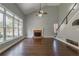 Bright living room with brick fireplace, hardwood floors, and large windows showcasing outdoor views at 2025 Fairway Crossing Dr, Woodstock, GA 30188