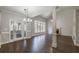 Open-concept dining area featuring hardwood floors, high ceilings, and large windows with backyard views at 2025 Fairway Crossing Dr, Woodstock, GA 30188