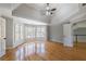 Bright main bedroom with hardwood floors, tray ceiling and a view of the back yard at 2025 Fairway Crossing Dr, Woodstock, GA 30188