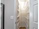 Walk-in pantry with ample shelving for organized storage and easy access to kitchen essentials at 2025 Fairway Crossing Dr, Woodstock, GA 30188
