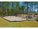 Community playground with swings, climbing structure, and picnic tables surrounded by green lawn at 2025 Fairway Crossing Dr, Woodstock, GA 30188