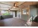 Relaxing screened porch featuring multiple ceiling fans and a backyard view at 2025 Fairway Crossing Dr, Woodstock, GA 30188