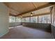 Screened sunroom with beadboard and dual ceiling fans, offering views of the backyard trees at 2025 Fairway Crossing Dr, Woodstock, GA 30188
