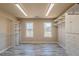 Spacious walk-in closet with shelving, windows, and laminate floors at 2025 Fairway Crossing Dr, Woodstock, GA 30188