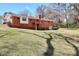 A spacious backyard featuring a well-maintained lawn and a brick home with a balcony at 1420 Stephenson Rd, Lithonia, GA 30058