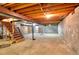 Unfinished basement with wooden staircase and concrete block walls at 1420 Stephenson Rd, Lithonia, GA 30058