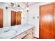 Bathroom featuring traditional fixtures, patterned wallpaper and a vanity sink at 1420 Stephenson Rd, Lithonia, GA 30058