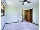 This bedroom features carpeted floors, a ceiling fan, and a window with bars for added security at 1420 Stephenson Rd, Lithonia, GA 30058