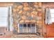 Cozy fireplace with a stone surround and vintage charm in a living space at 1420 Stephenson Rd, Lithonia, GA 30058