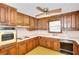 Well-lit kitchen features wood cabinetry and a functional layout at 1420 Stephenson Rd, Lithonia, GA 30058