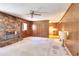 Cozy living area with stone fireplace, wood paneling and view to the kitchen at 1420 Stephenson Rd, Lithonia, GA 30058