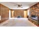 Cozy living room featuring wood paneling and a stone fireplace, perfect for relaxing at 1420 Stephenson Rd, Lithonia, GA 30058