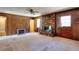 Classic living room with a stone fireplace, wood paneling, and ample natural light at 1420 Stephenson Rd, Lithonia, GA 30058