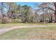 Expansive grassy backyard bordered by mature trees and foliage at 1420 Stephenson Rd, Lithonia, GA 30058