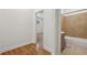 A bathroom featuring a shower with beige tiling and updated vanity adjacent to the entry of a bedroom at 1615 Orlando Sw St, Atlanta, GA 30311