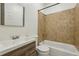 Bathroom featuring a bathtub and modern vanity with brown tile at 1615 Orlando Sw St, Atlanta, GA 30311