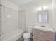 Bathroom featuring a modern vanity with drawers and a bathtub with white subway tile at 1615 Orlando Sw St, Atlanta, GA 30311