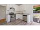 Modern kitchen with white cabinets and stainless steel appliances at 1615 Orlando Sw St, Atlanta, GA 30311