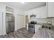 Modern kitchen features white cabinets and stainless steel appliances at 1615 Orlando Sw St, Atlanta, GA 30311