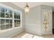 Dining room features tile flooring, a modern light fixture, and a door that leads to a patio at 1715 Eden Valley Ct, Loganville, GA 30052