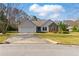 Charming single Gathering home featuring a two-car garage, well-maintained lawn, and partial stone accents at 1715 Eden Valley Ct, Loganville, GA 30052
