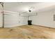 Spacious garage with white door and concrete floor at 1715 Eden Valley Ct, Loganville, GA 30052