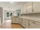 Kitchen boasts white cabinets, bright countertops, tile floors and stainless-steel dishwasher at 1715 Eden Valley Ct, Loganville, GA 30052