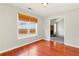 Bright living room with gleaming hardwood floors, large window, and open access to the living area and fireplace at 1715 Eden Valley Ct, Loganville, GA 30052