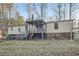View of the back of the house, deck and swing set in a spacious yard at 355 Double D Rd, Temple, GA 30179