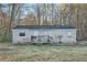 Single story home featuring a front porch with siding, surrounded by trees and an ample front yard at 355 Double D Rd, Temple, GA 30179