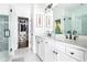 Modern bathroom with dual sinks, bright white cabinets, glass shower and walk-in closet at 6701 Prelude Dr, Atlanta, GA 30328