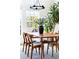The dining area features a modern table, wooden chairs, and lots of natural light to fill the room at 6701 Prelude Dr, Atlanta, GA 30328