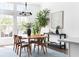 Dining room showcases a modern chandelier, large windows, and a stylish table, filled with natural light at 6701 Prelude Dr, Atlanta, GA 30328