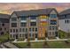 Modern townhome showcasing brick facade, black trim, and lush landscaping at 6701 Prelude Dr, Atlanta, GA 30328