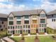 Modern townhome showcasing brick facade, black trim, and lush landscaping at 6701 Prelude Dr, Atlanta, GA 30328